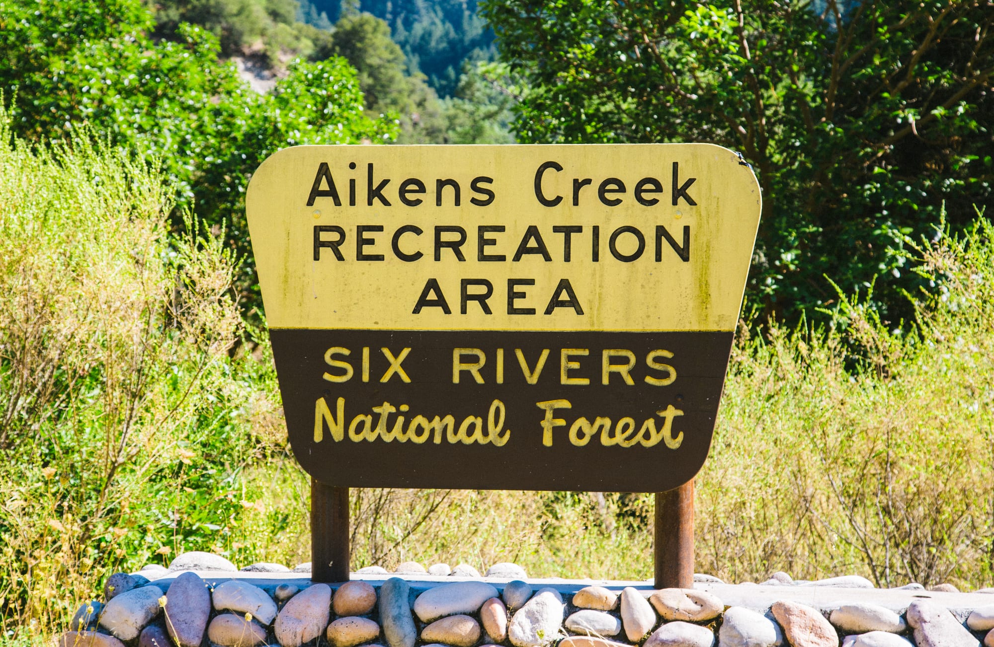 Sign for the Aikens Creek Recreation Area in Six Rivers National Forest, California, on the Bigfoot Scenic Byway near Bluff Creek