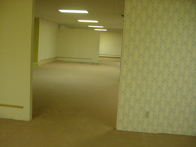 The original 2002 photograph of the yellow-walled, fluorescent-lit second floor at 807 Oregon Street in Oshkosh, Wisconsin, that later became the Backrooms image