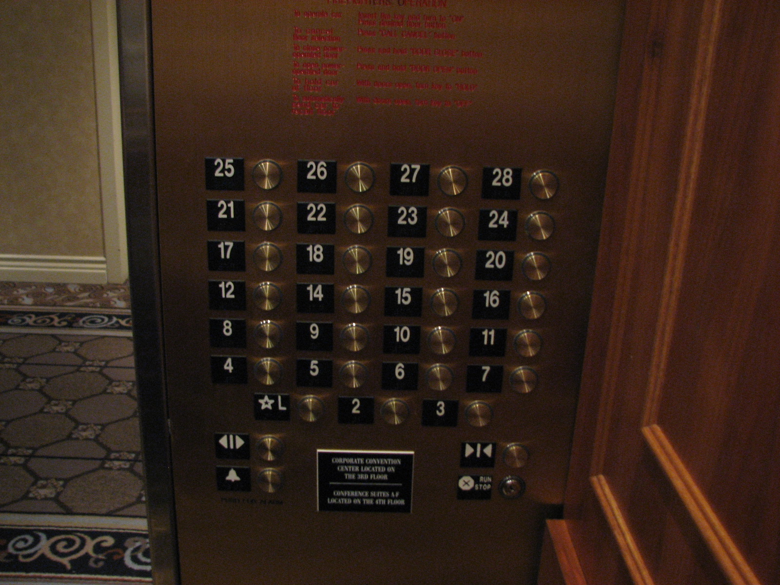 Elevator panel whose floor labels jump from 12 to 14, omitting the number 13