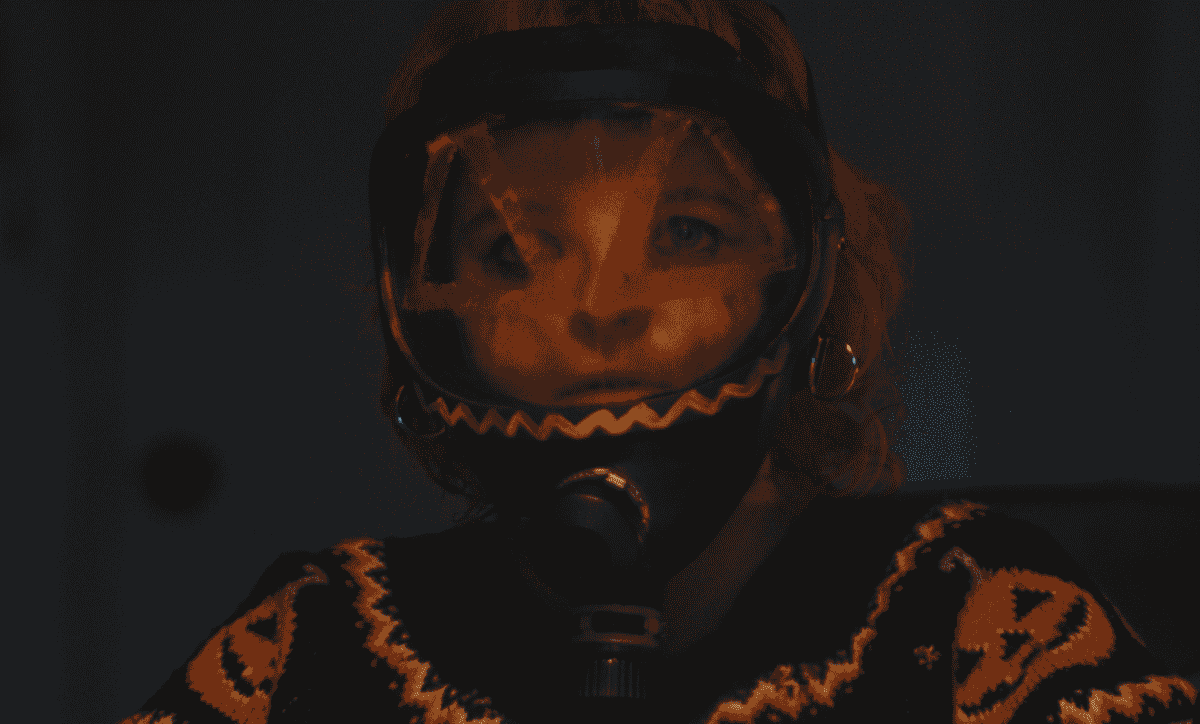 A character wearing pumpkin-patterned protective headgear in an official Hallowarrior film still
