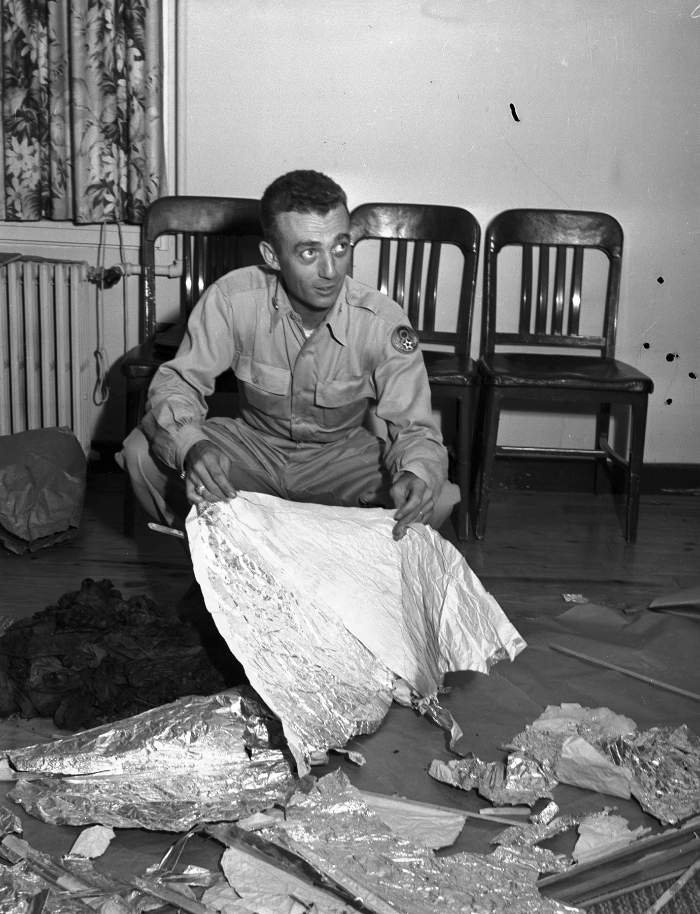 Major Jesse Marcel holding recovered debris at Fort Worth Army Air Field, July 8, 1947