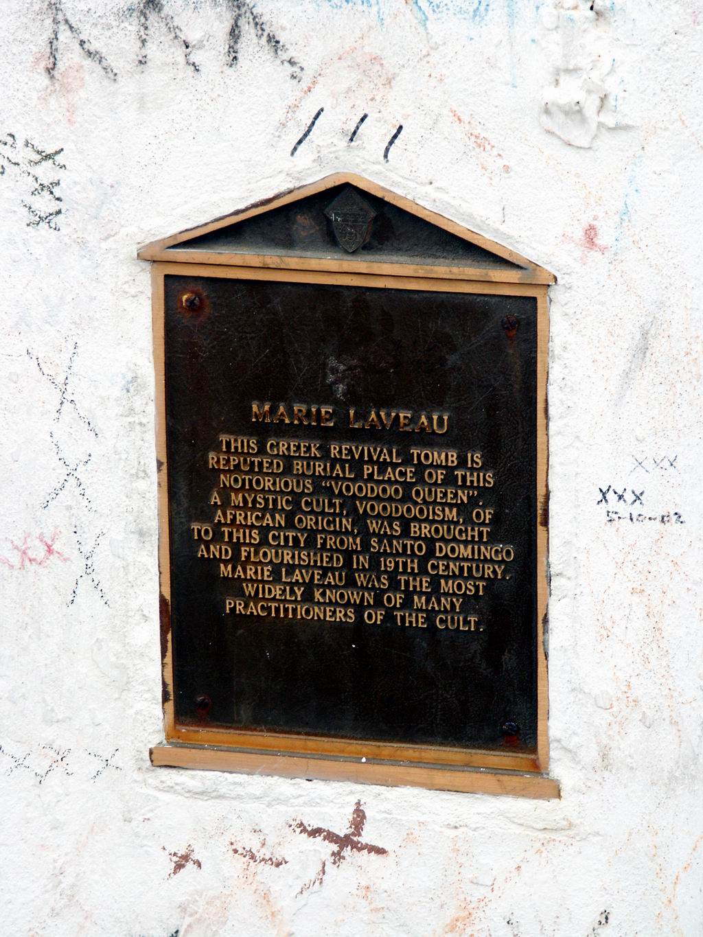2003 photograph of the Marie Laveau tomb plaque and three X marks on the surrounding plaster in St. Louis Cemetery No. 1