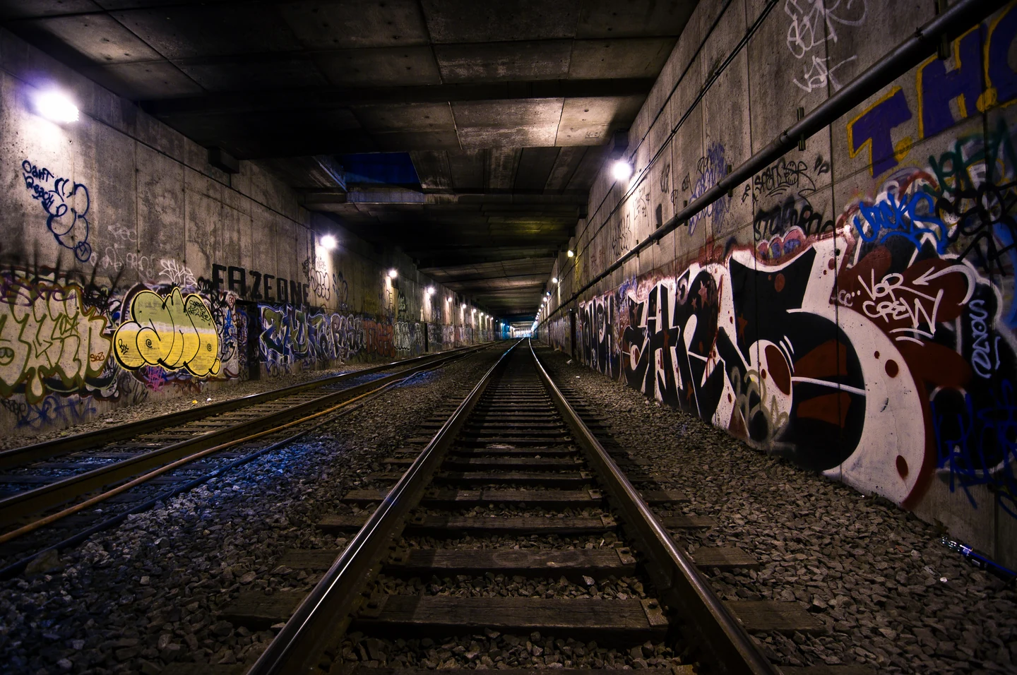 Rails receding through the graffiti-covered Freedom Tunnel under Riverside Park, photographed in 2013; a real New York site, not a still from Molepeople