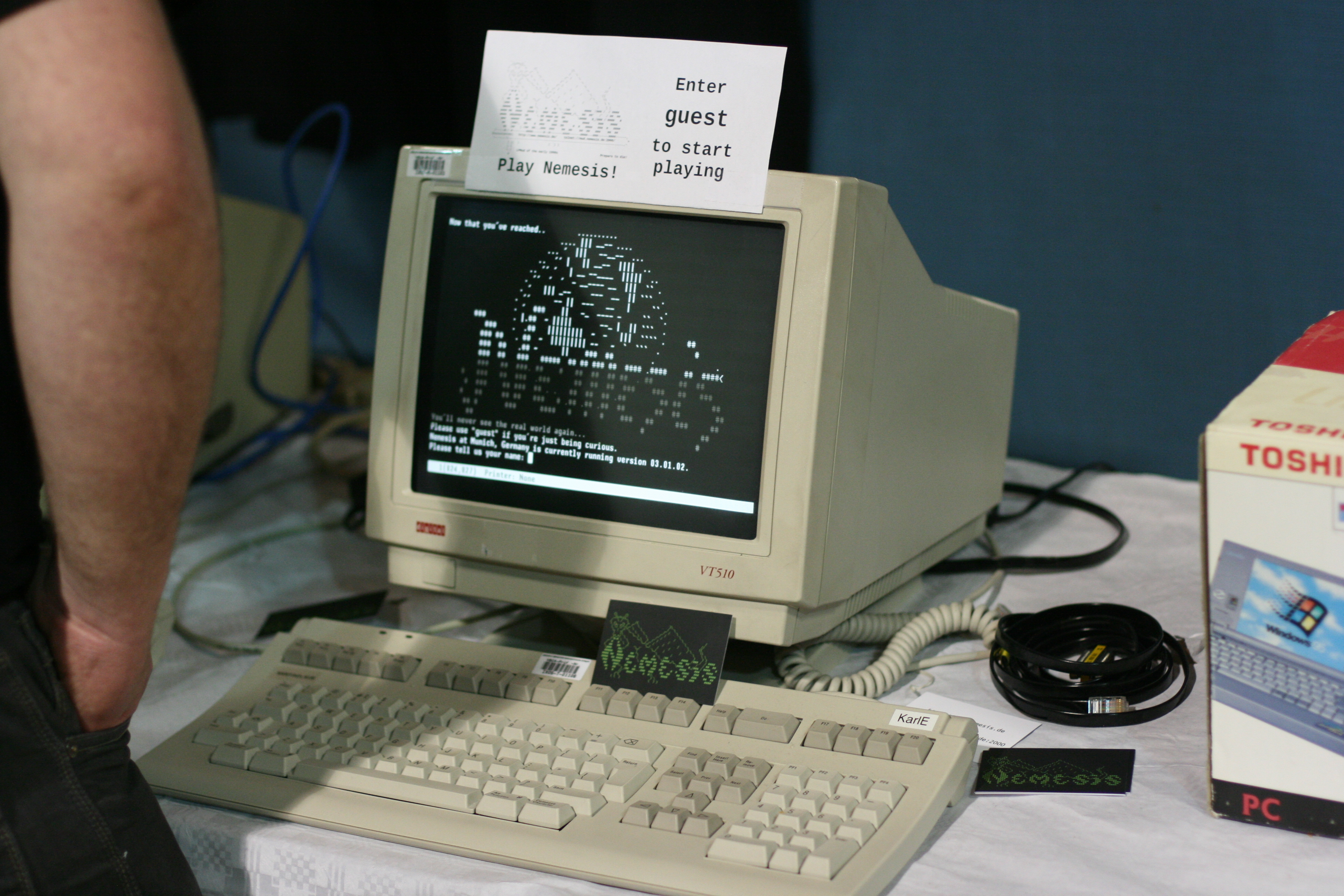 A computer terminal photographed in a museum, illustrating the networked-computing context of collaborative online writing