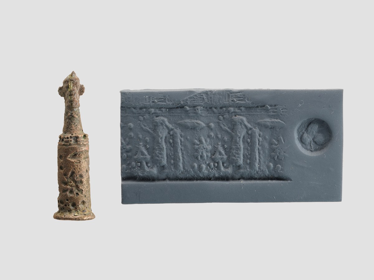 Small bronze stamp-cylinder seal topped with a Pazuzu head, shown beside its modern clay impression showing a cultic scene