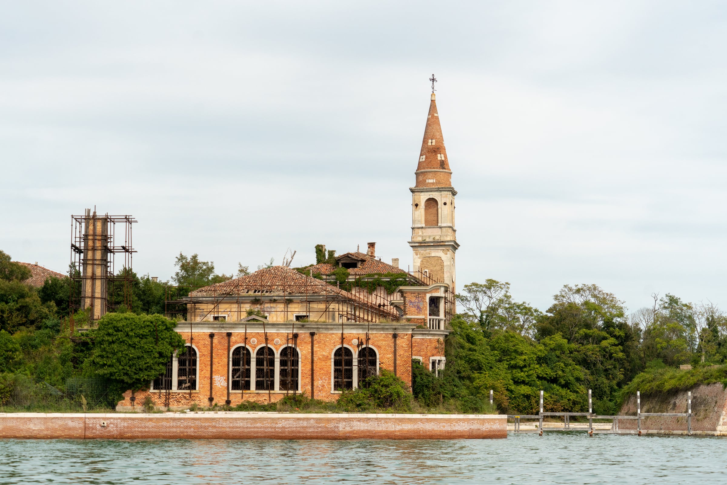 Poveglia's bell tower and former hospital buildings viewed from the Venetian Lagoon in 2024