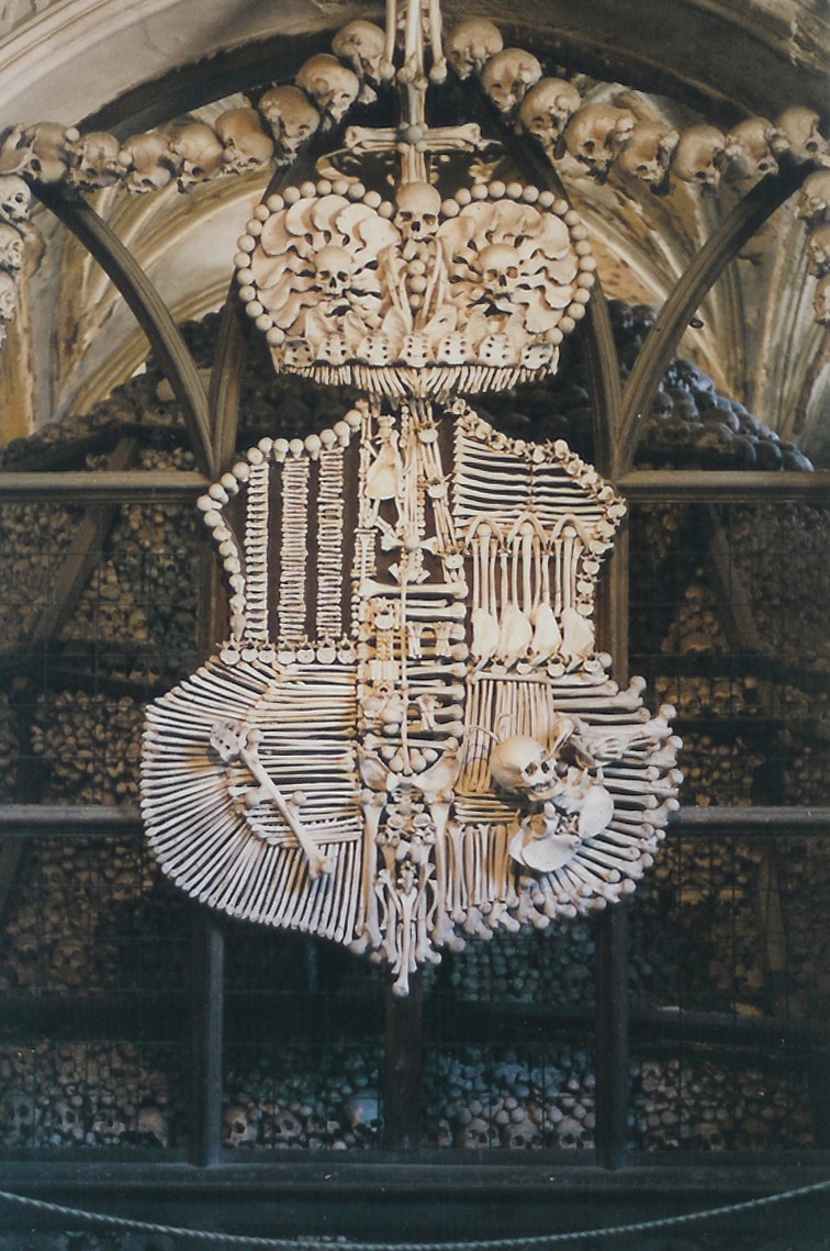 The bone chandelier at Sedlec Ossuary, made from human skulls and bones and surrounded by garlands of skulls along the chapel vaulting