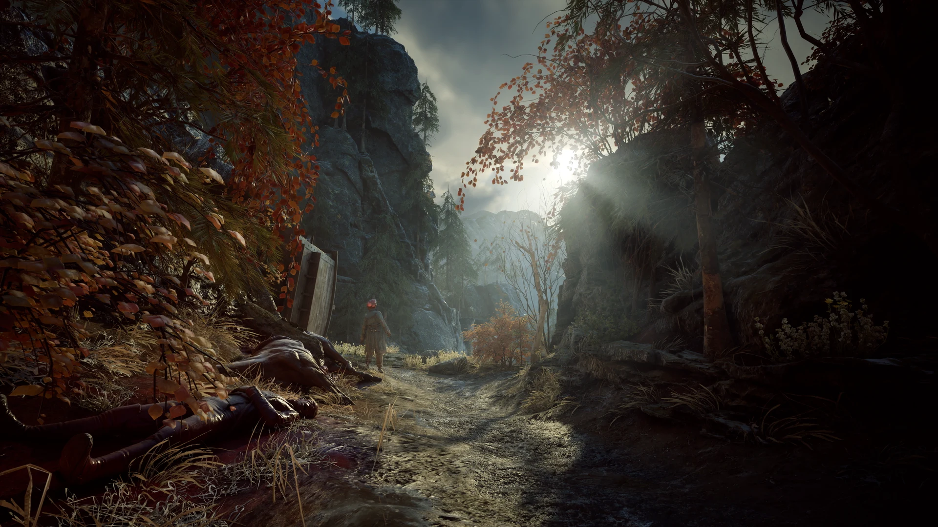 A soldier and fallen bodies along a wooded path between ruined stone walls in Valor Mortis