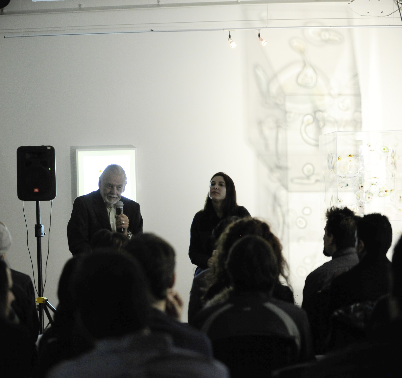 George A. Romero speaking into a handheld microphone before an audience in 2009